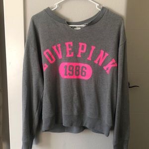 Gray sweater with pink words that say “love pink 1986”